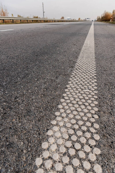 white lane on grey asphalt on empty highway 