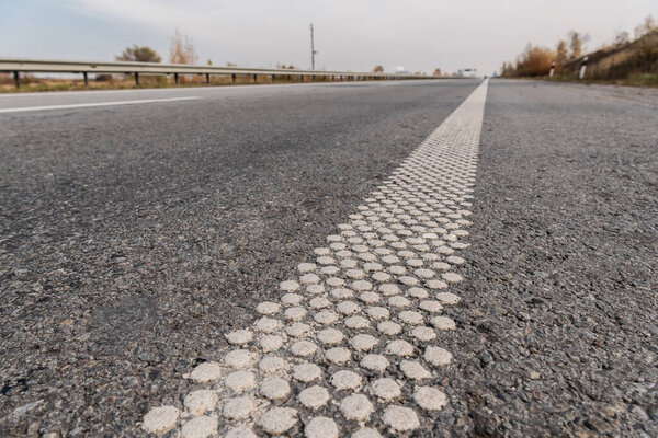 lane on grey asphalt on empty highway 