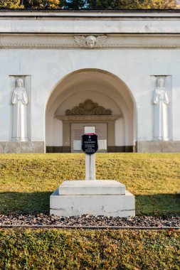 LVIV, UKRAINE - OCTOBER 23, 2019: grave of Adam Pogonowsky and arch with sculptures in polish part of lychakiv cemetery clipart