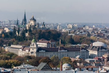LVIV, UKRAINE - OCTOBER 23, 2019: aerial view of city hall and dominican church in historical center of city clipart