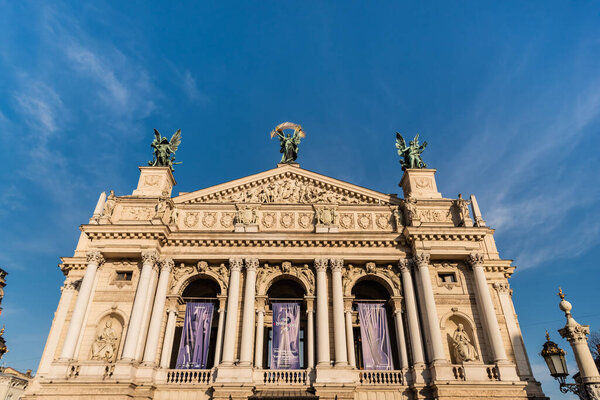 LVIV, UKRAINE - OCTOBER 23, 2019: front view of Lviv Theatre of Opera and Ballet against blue sky