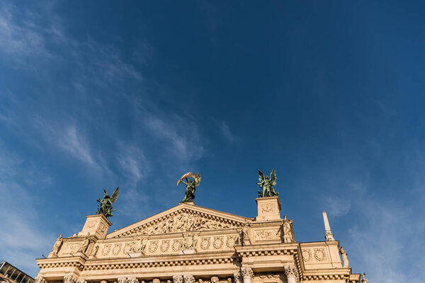 Lviv Theatre of Opera and Ballet in sunlight against blue sky