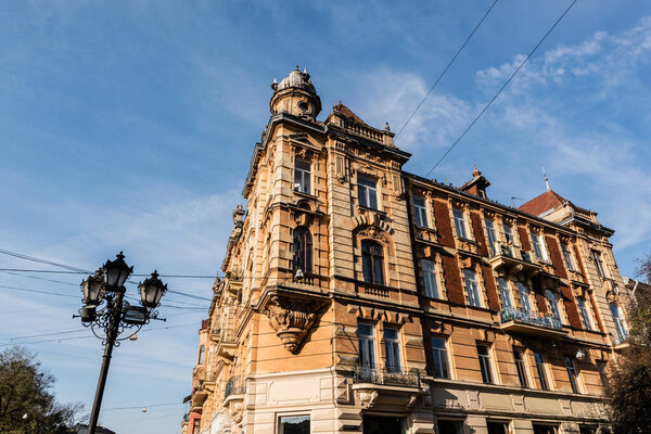 vintage city lamp near neoclassical building in lviv, ukraine