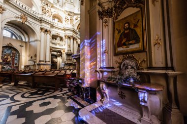 LVIV, UKRAINE - OCTOBER 23, 2019: interior of dominican church with mosaic floor and rich decoration with lighting clipart