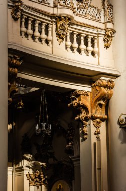 LVIV, UKRAINE - OCTOBER 23, 2019: balcony with balustrade, decorated with gilded elements in dominican church clipart