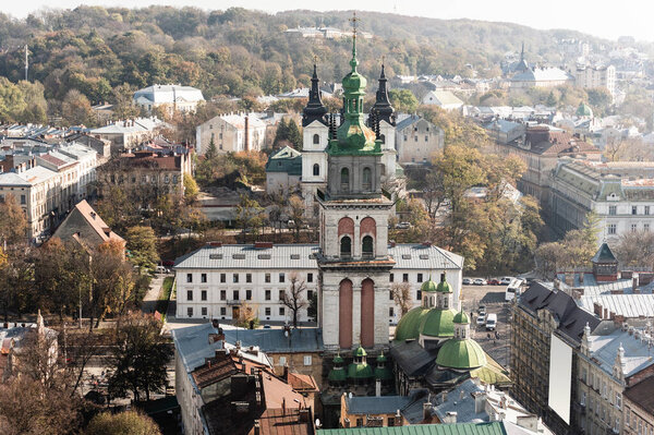 aerial view of carmelite church, korniakt tower and houses in historical center lviv, ukraine