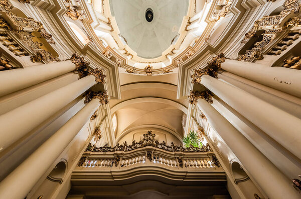LVIV, UKRAINE - OCTOBER 23, 2019: bottom view of colums, balustrade and ceiling in dominican church