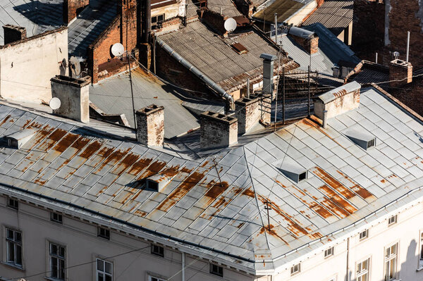 aerial view of old houses with rusty metallic roofs in lviv, ukraine