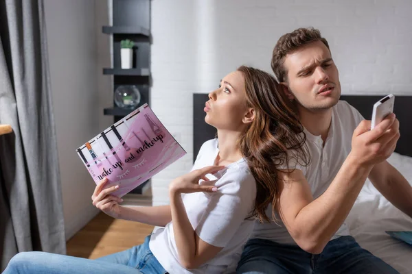 Woman Woman Holding Magazine While Feeling Hot Man Remote Controller — Stock Photo, Image