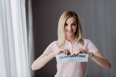 happy woman ripping paper with quarantine lettering  clipart