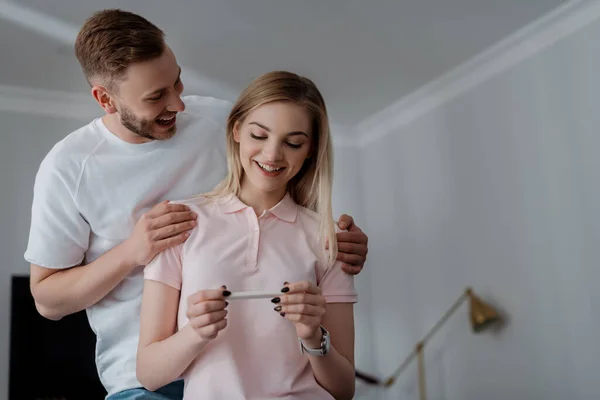 Happy Woman Holding Pregnancy Test Positive Result Cheerful Boyfriend — Stock Photo, Image