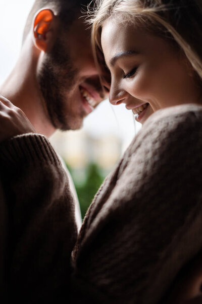 selective focus of cheerful girl with closed eyes near happy man 