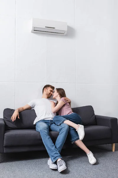 Smiling Girlfriend Boyfriend Hugging Looking Each Other Home Air Conditioner — Stock Photo, Image