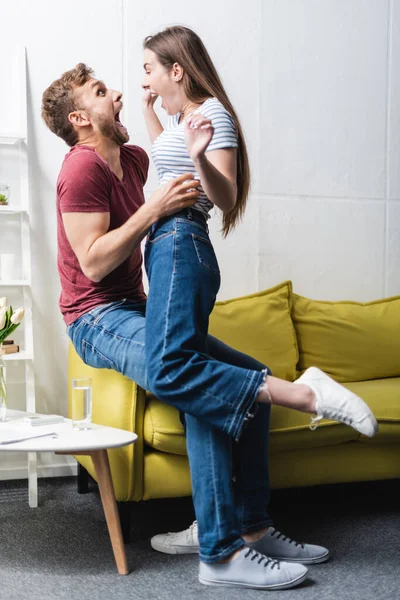 Excited Beautiful Young Couple Embracing Home — Stock Photo, Image