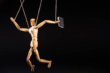 wooden marionette on strings with suitcase isolated on black clipart