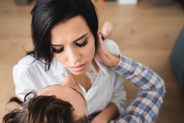 Overhead view of man hugging beautiful girl at home 