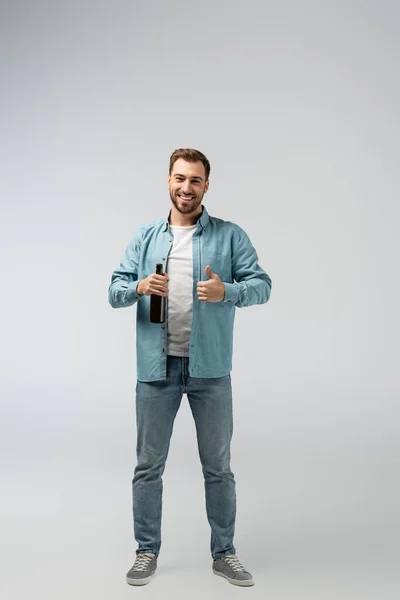 Smiling Young Man Bottle Beer Showing Thumb Isolated Grey — Stock Photo, Image