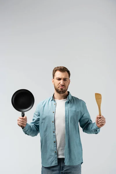 Displeased Young Man Frying Pan Spatula Isolated Grey — Stock Photo, Image