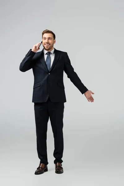 Smiling Handsome Businessman Suit Talking Smartphone Isolated Grey — Stock Photo, Image