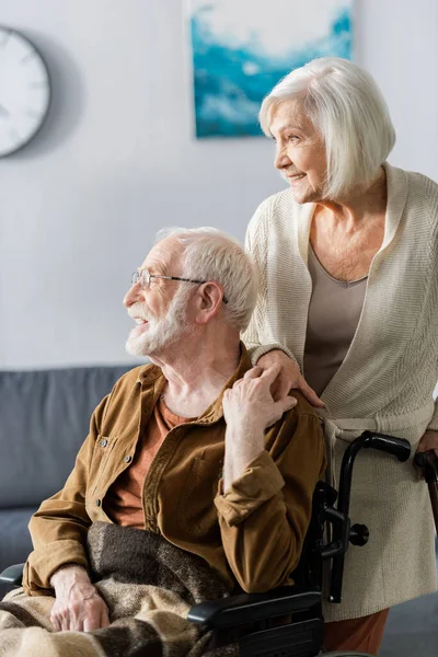 Smiling Senior Woman Cheerful Disabled Husband Holding Hands Looking Away — Stock Photo, Image