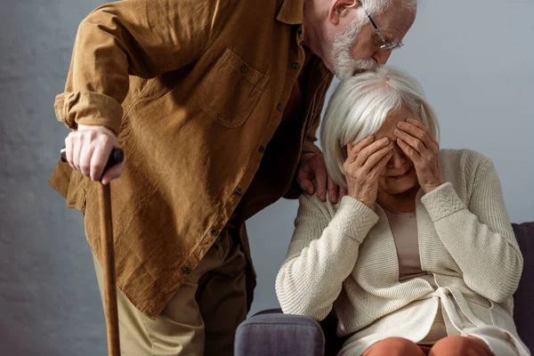 Senior Man Walking Stick Kissing Head Diseased Wife Crying Covering — Stock Photo, Image
