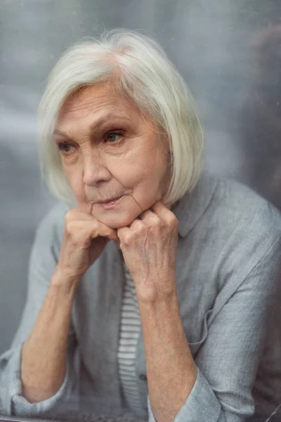 Sad Senior Woman Looking Away Window Glass — Stock Photo, Image