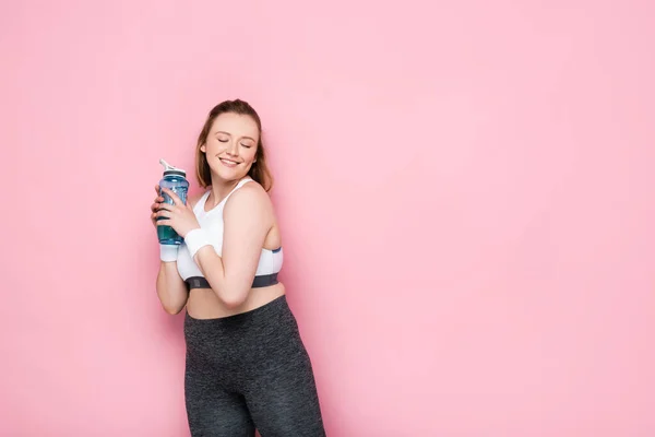 Excited Overweight Girl Holding Sports Bottle Smiling Closed Eyes Isolated — Stock Photo, Image