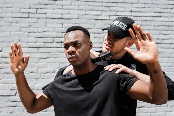 Police Officer Baton Detaining African American Man Raised Hands Racism — Stock Photo, Image