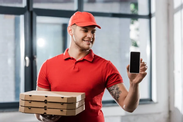 Cheerful Delivery Man Cap Holding Smartphone Blank Screen Pizza Boxes — Stock Photo, Image