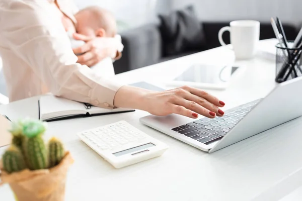 Cropped View Mother Breastfeeding Infant Son While Using Laptop Home — Stock Photo, Image