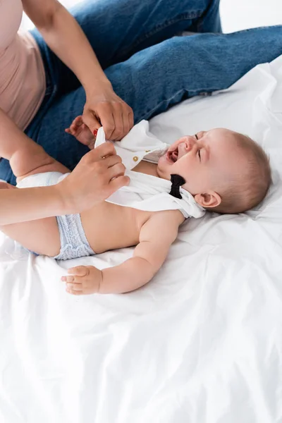 Mother Sitting Bed Wearing Baby Romper Crying Infant Son — Stock Photo, Image