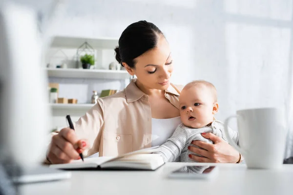 Selective Focus Mother Holding Pen Looking Cute Infant Son Smartphone — Stock Photo, Image