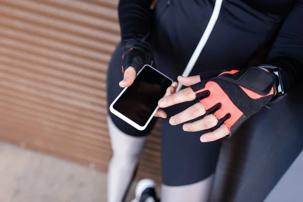 Vista Recortada Joven Deportista Sosteniendo Teléfono Inteligente Con Pantalla Blanco — Foto de Stock