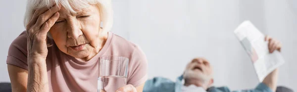 Panoramic Shot Elderly Woman Holding Glass Water Husband Newspaper Suffering — Stock Photo, Image