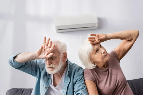 Senior Couple Suffering Heat While Sitting Air Conditioner Home — Stock Photo, Image
