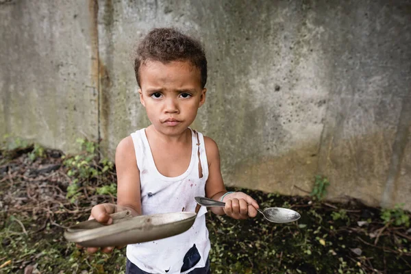 Dissatisfied African American Boy Holding Dirty Plate Spoon Looking Camera — Stock Photo, Image