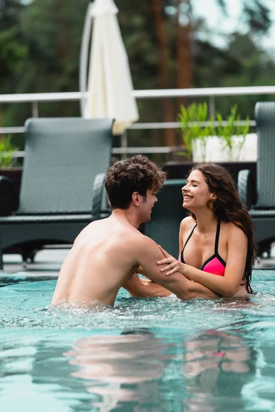 Glücklicher Muskulöser Mann Berührt Fröhliches Mädchen Schwimmbad — Stockfoto