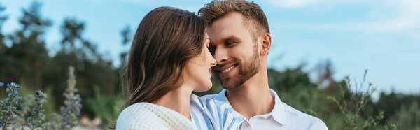 horizontal image of happy couple smiling and looking at each other 
