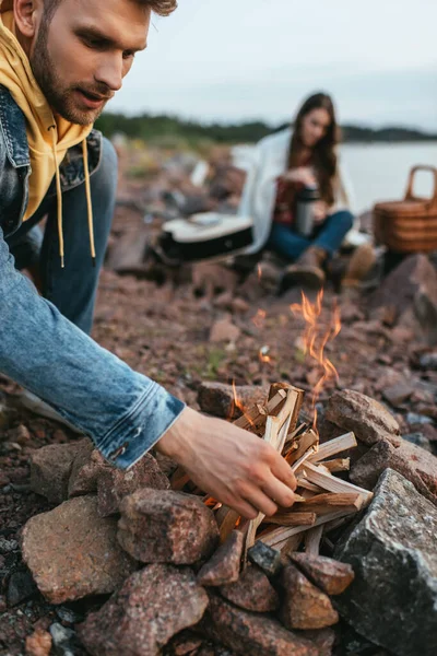 Selective Focus Handsome Man Touching Sticks While Making Bonfire Woman — Stock Photo, Image