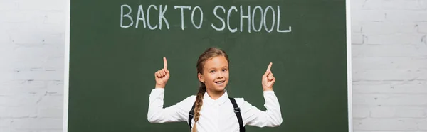 Horizontal Concept Happy Schoolgirl Pointing Fingers Back School Inscription Chalkboard — Stock Photo, Image