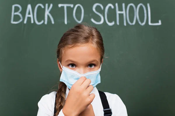 Messa Fuoco Selettiva Della Studentessa Carina Toccare Maschera Medica Guardando — Foto Stock