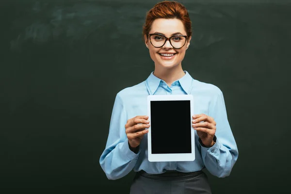 Cheerful Teacher Showing Digital Tablet Blank Screen While Standing Chalkboard — Stock Photo, Image