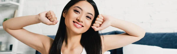 Horizontal Crop Smiling Asian Woman Looking Camera While Stretching Bedroom — Stock Photo, Image