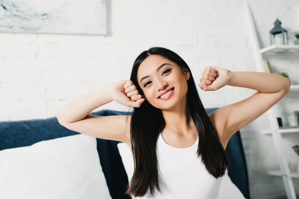 Cheerful Asian Girl Stretching Bedroom Morning — Stock Photo, Image