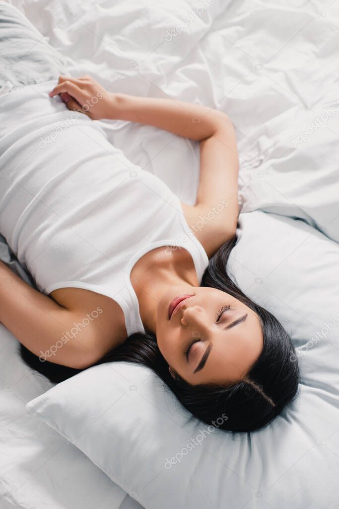 Top view of beautiful asian woman sleeping on bed during morning 