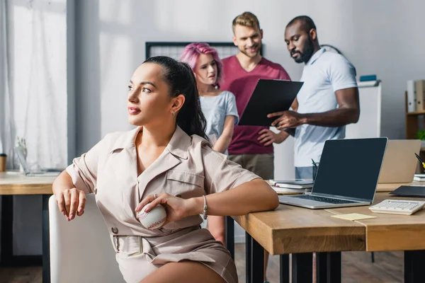 Selective Focus Businesswoman Holding Baseball Ball While Multicultural Colleagues Working — Stock Photo, Image