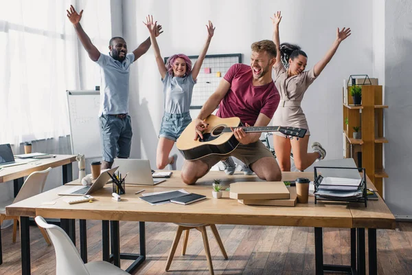 Selective Focus Multiethnic Business People Jumping While Colleague Playing Acoustic — Stock Photo, Image