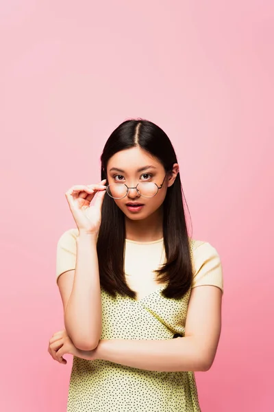 Attractive Asian Girl Touching Glasses Isolated Pink — Stock Photo, Image