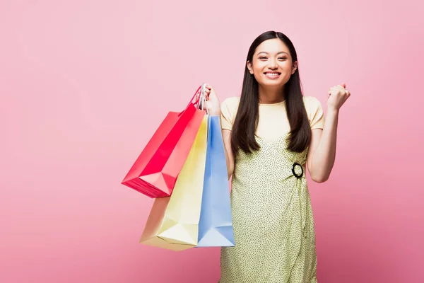 Excited Asian Girl Looking Camera While Holding Shopping Bags Pink — Stock Photo, Image