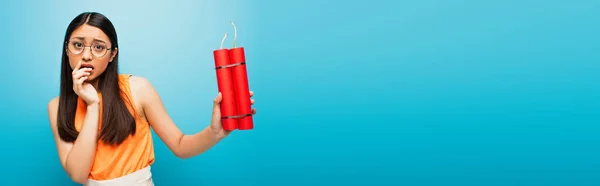 Panoramic Shot Scared Asian Girl Glasses Holding Dynamite Sticks Blue — Stock Photo, Image